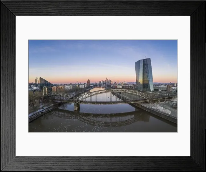Framed Print : Aerial panoramic picture of Deutschherrnbrücke with Frankfurt skyline during sunrise in winter Framed Print : Aerial panoramic picture of Deutschherrnbrücke with Frankfurt skyline during sunrise in winter