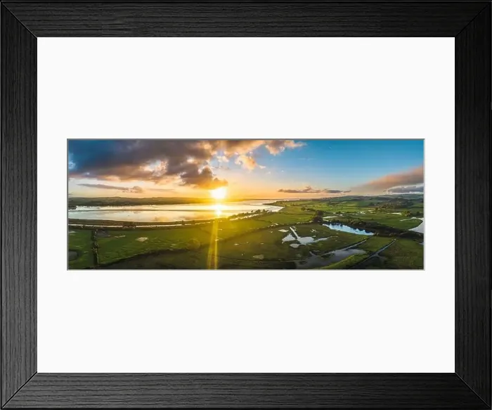 Framed Print : Sunrise over Wetlands and meadows in RSPB Exminster and Powderham Marshe from a drone, Exeter, Devon, England Framed Print : Sunrise over Wetlands and meadows in RSPB Exminster and Powderham Marshe from a drone, Exeter, Devon, England