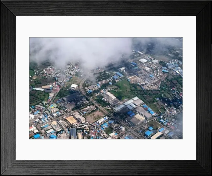 Framed Print : An aerial view of Mumbai's skyline passing over a building with roads and bridges Framed Print : An aerial view of Mumbai's skyline passing over a building with roads and bridges