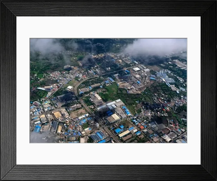 Framed Print : An aerial view of Mumbai's skyline passing over a building with roads and bridges Framed Print : An aerial view of Mumbai's skyline passing over a building with roads and bridges