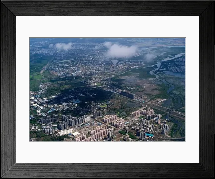 Framed Print : An aerial view of Mumbai's skyline passing over a building with roads and bridges Framed Print : An aerial view of Mumbai's skyline passing over a building with roads and bridges