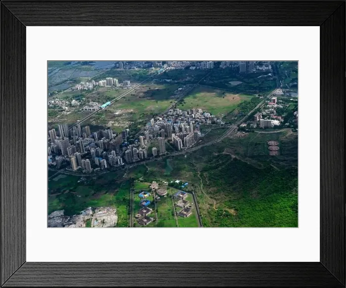 Framed Print : An aerial view of Mumbai's skyline passing over a building with roads and bridges Framed Print : An aerial view of Mumbai's skyline passing over a building with roads and bridges