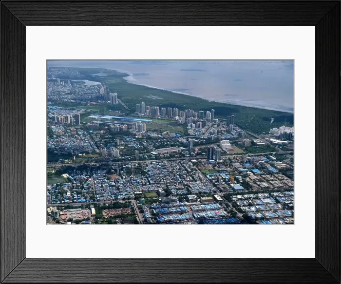 Framed Print : An aerial view of Mumbai's skyline passing over a building with roads and bridges Framed Print : An aerial view of Mumbai's skyline passing over a building with roads and bridges