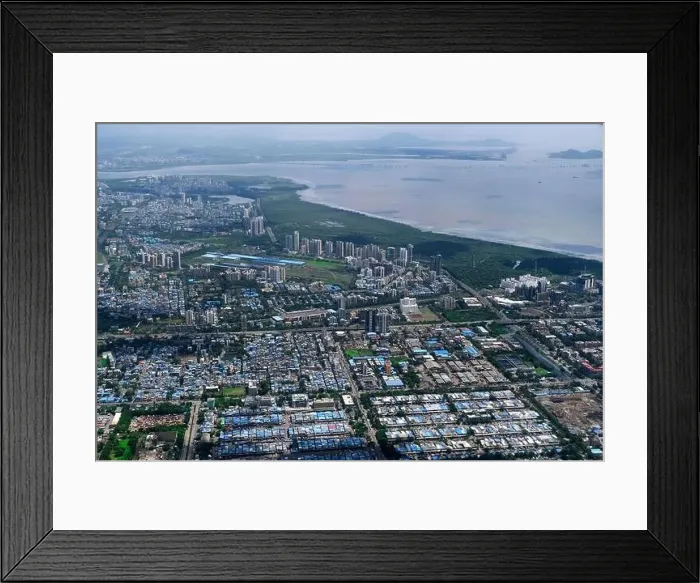 Framed Print : An aerial view of Mumbai's skyline passing over a building with roads and bridges Framed Print : An aerial view of Mumbai's skyline passing over a building with roads and bridges