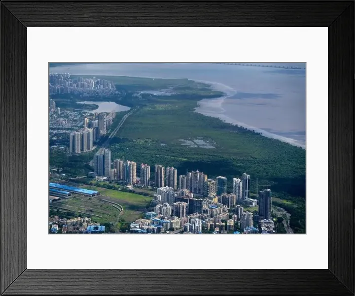Framed Print : An aerial view of Mumbai's skyline passing over a building with roads and bridges Framed Print : An aerial view of Mumbai's skyline passing over a building with roads and bridges