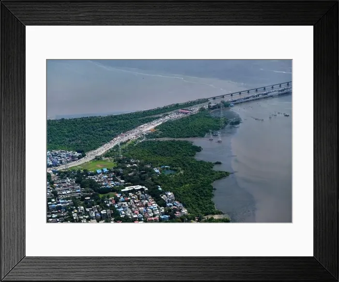 Framed Print : An aerial view of Mumbai's skyline passing over a building with roads and bridges Framed Print : An aerial view of Mumbai's skyline passing over a building with roads and bridges