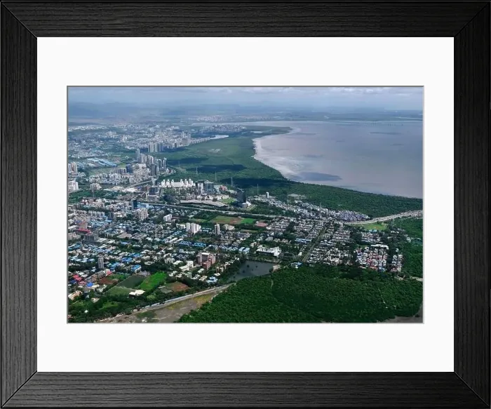 Framed Print : An aerial view of Mumbai's skyline passing over a building with roads and bridges Framed Print : An aerial view of Mumbai's skyline passing over a building with roads and bridges