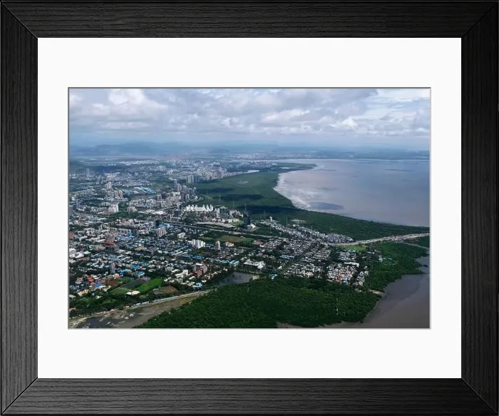 Framed Print : An aerial view of Mumbai's skyline passing over a building with roads and bridges Framed Print : An aerial view of Mumbai's skyline passing over a building with roads and bridges