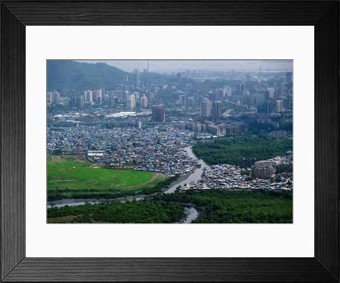 Framed Print : An aerial view of Mumbai's skyline passing over a building with roads and bridges Framed Print : An aerial view of Mumbai's skyline passing over a building with roads and bridges