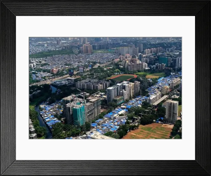Framed Print : An aerial view of Mumbai's skyline passing over a building with roads and bridges Framed Print : An aerial view of Mumbai's skyline passing over a building with roads and bridges