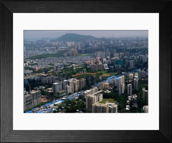 Framed Print : An aerial view of Mumbai's skyline passing over a building with roads and bridges Framed Print : An aerial view of Mumbai's skyline passing over a building with roads and bridges