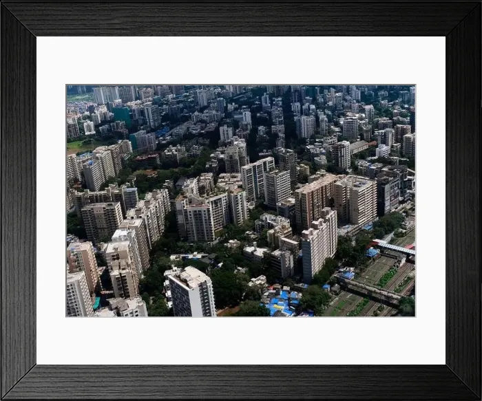 Framed Print : An aerial view of Mumbai's skyline passing over a building with roads and bridges Framed Print : An aerial view of Mumbai's skyline passing over a building with roads and bridges