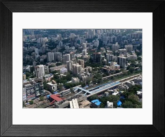 Framed Print : An aerial view of Mumbai's skyline passing over a building with roads and bridges Framed Print : An aerial view of Mumbai's skyline passing over a building with roads and bridges