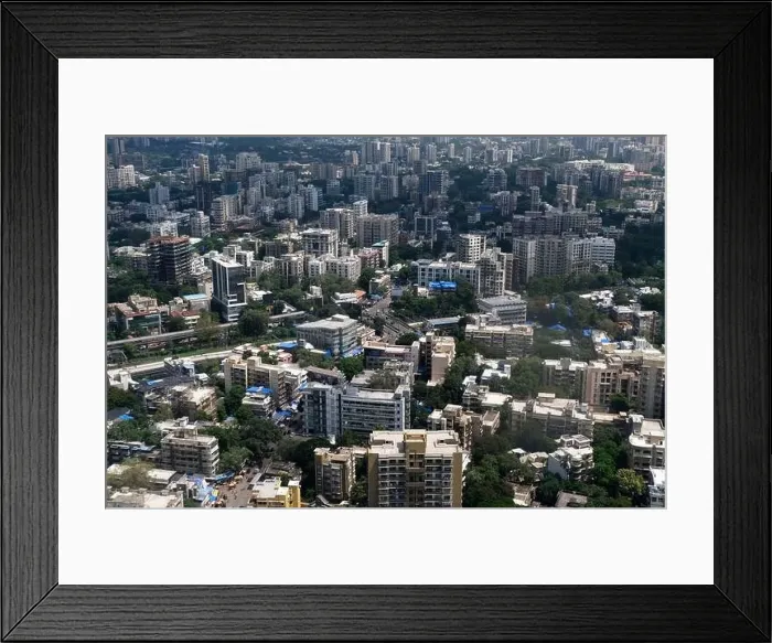 Framed Print : An aerial view of Mumbai's skyline passing over a building with roads and bridges Framed Print : An aerial view of Mumbai's skyline passing over a building with roads and bridges