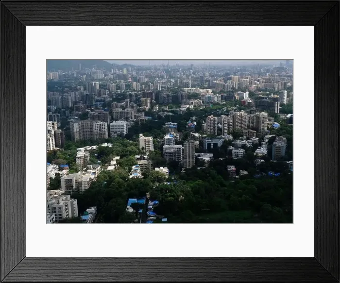 Framed Print : An aerial view of Mumbai's skyline passing over a building with roads and bridges Framed Print : An aerial view of Mumbai's skyline passing over a building with roads and bridges