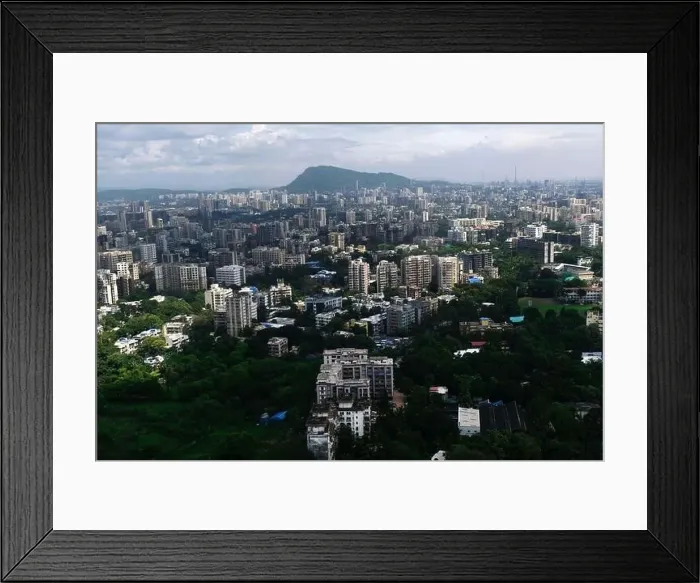 Framed Print : An aerial view of Mumbai's skyline passing over a building with roads and bridges Framed Print : An aerial view of Mumbai's skyline passing over a building with roads and bridges