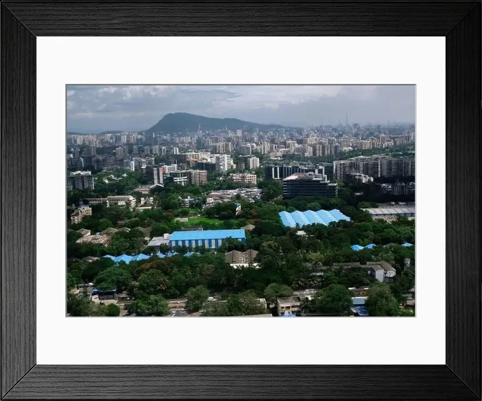 Framed Print : An aerial view of Mumbai's skyline passing over a building with roads and bridges