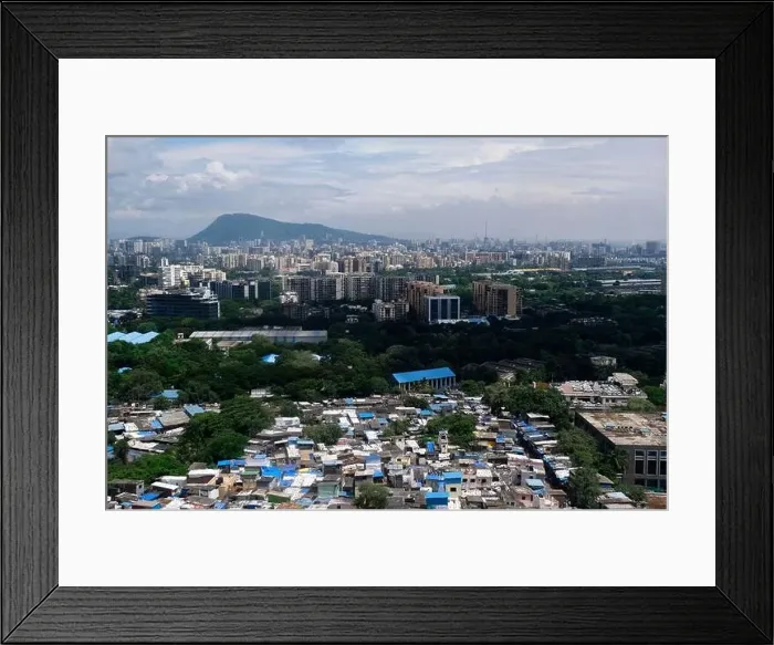 Framed Print : An aerial view of Mumbai's skyline passing over a building with roads and bridges Framed Print : An aerial view of Mumbai's skyline passing over a building with roads and bridges