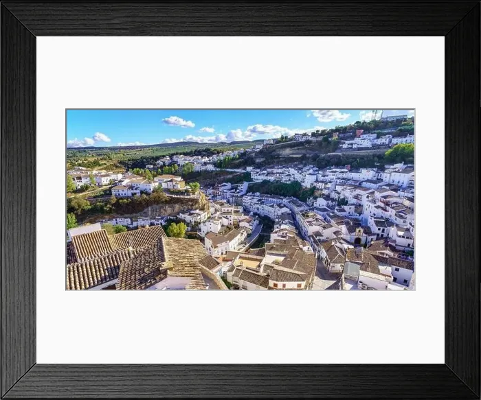 Framed Print : Aerial view of a beautiful Andalusian village of white houses built on the mountainside, Setenil de las Bodegas, Cadiz Framed Print : Aerial view of a beautiful Andalusian village of white houses built on the mountainside, Setenil de las Bodegas, Cadiz