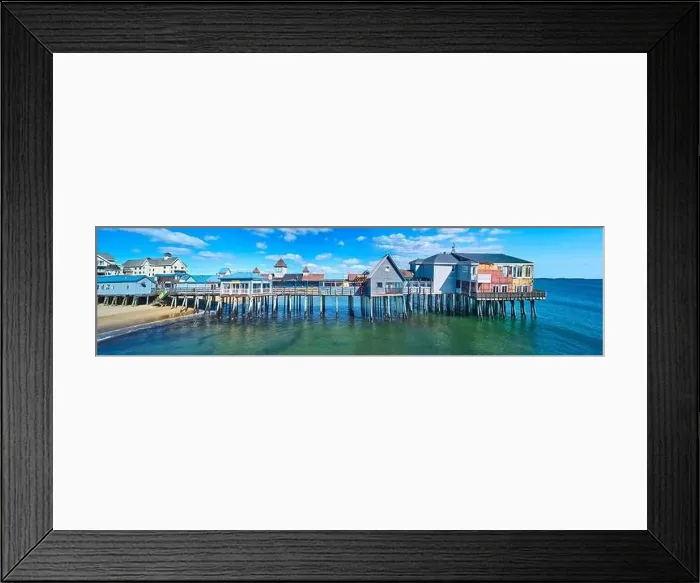 Framed Print : Stunning side profile of entire old wood pier in Maine covered in shops and buildings on beach Framed Print : Stunning side profile of entire old wood pier in Maine covered in shops and buildings on beach