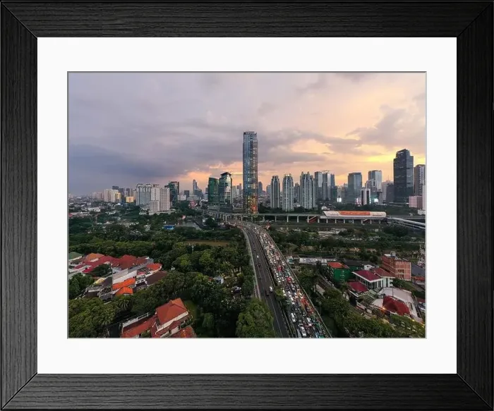 Framed Print : Aerial view of office buildings in Jakarta central business district and noise cloud when sunset Framed Print : Aerial view of office buildings in Jakarta central business district and noise cloud when sunset