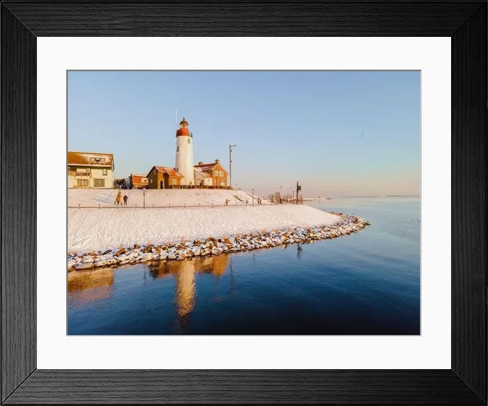 Framed Print : Lighthouse of Urk during winter with snow landscape in the Netherlands at sunset Framed Print : Lighthouse of Urk during winter with snow landscape in the Netherlands at sunset