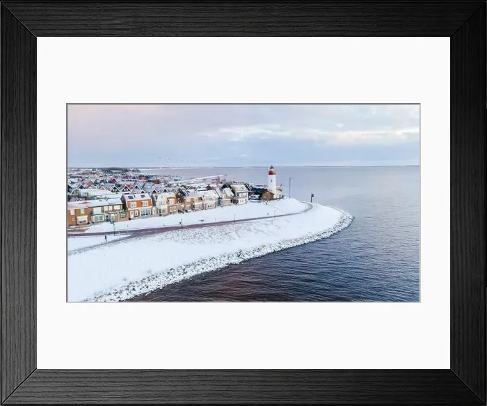 Framed Print : Lighthouse of Urk during winter with snow landscape in the Netherlands. Dutch village in winter Framed Print : Lighthouse of Urk during winter with snow landscape in the Netherlands. Dutch village in winter