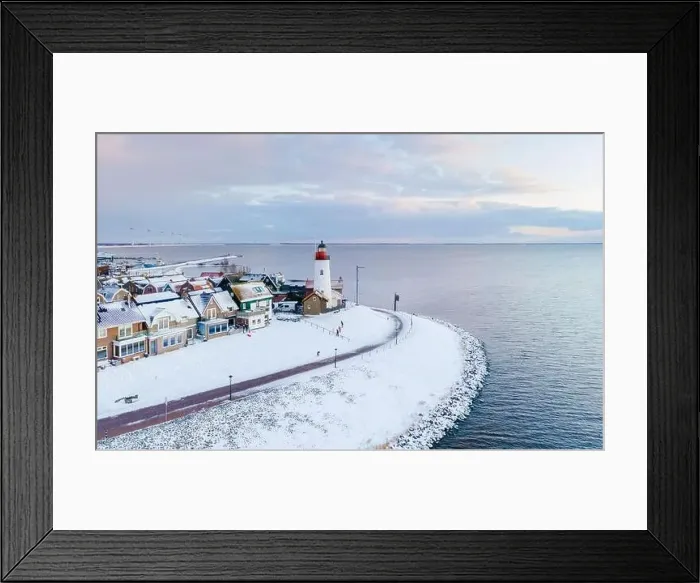 Framed Print : Lighthouse of Urk during winter with snow landscape in the Netherlands. Dutch old village