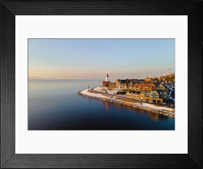Framed Print : Lighthouse of Urk during winter with snow landscape in the Netherlands. Dutch village in winter with snow Framed Print : Lighthouse of Urk during winter with snow landscape in the Netherlands. Dutch village in winter with snow