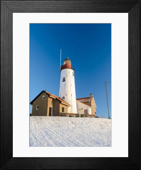 Framed Print : Lighthouse of Urk during winter with snow landscape in the Netherlands Framed Print : Lighthouse of Urk during winter with snow landscape in the Netherlands