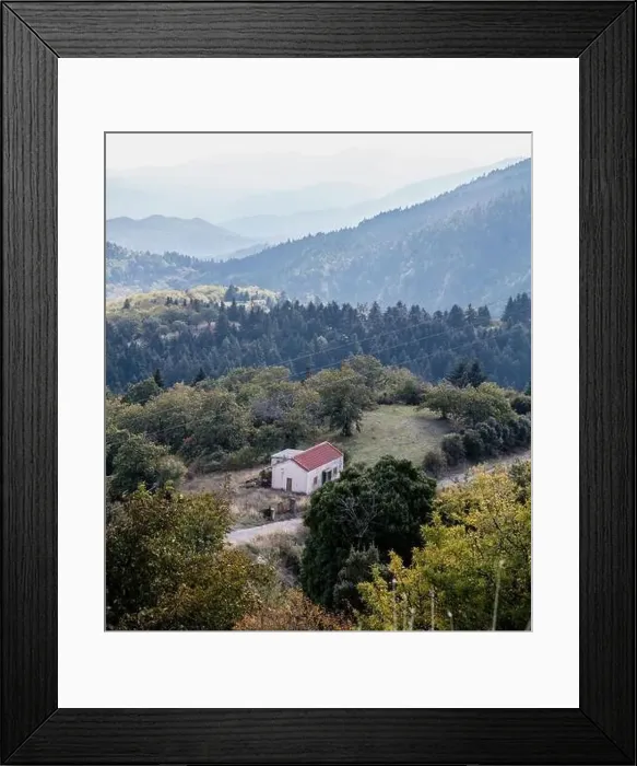 Framed Print : Lonely small house in fir forest, cloudy blue sky and mountains background, Aerial drone view Framed Print : Lonely small house in fir forest, cloudy blue sky and mountains background, Aerial drone view