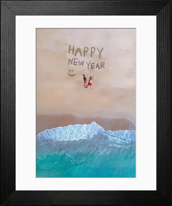 Framed Print : Happy new year sign on the beach with a couple in the sand and Christmas hat in Thailand on the beach Khao Lak Framed Print : Happy new year sign on the beach with a couple in the sand and Christmas hat in Thailand on the beach Khao Lak