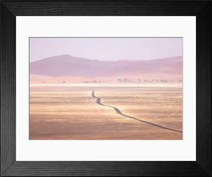 Framed Print : Drone view of arid land with hills and lonely route running through desert Framed Print : Drone view of arid land with hills and lonely route running through desert