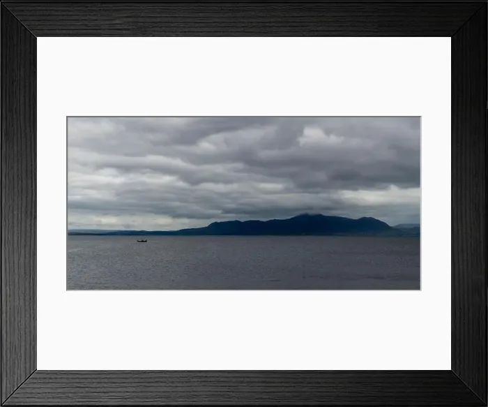 Framed Print : A single fishing boat in a deep blue ocean under a cloudy sky with coastal mountains in the background Framed Print : A single fishing boat in a deep blue ocean under a cloudy sky with coastal mountains in the background