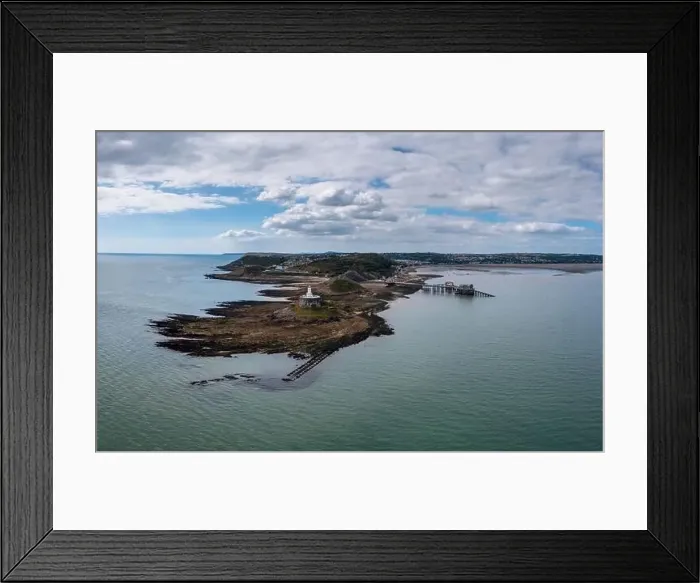 Framed Print : View of the Mumbles headland with the historic lighthouse and piers in Swansea Bay