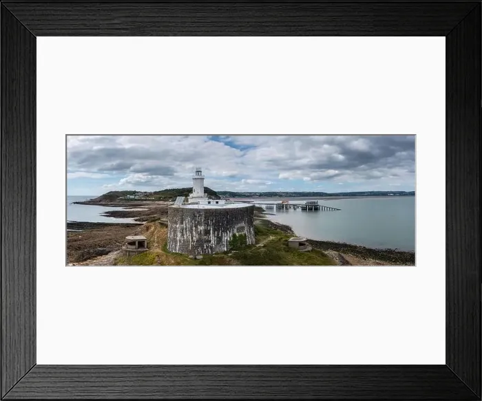 Framed Print : View of the Mumbles headland with the historic lighthouse and piers in Swansea Bay