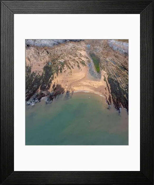 Framed Print : Top-down view of a rocky cove with sandy beach and turquoise ocean water Framed Print : Top-down view of a rocky cove with sandy beach and turquoise ocean water