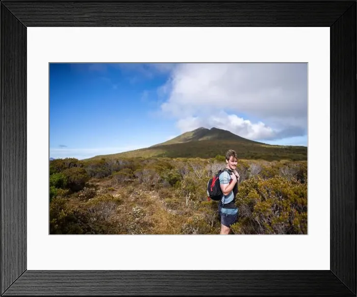 Framed Print : man hiking up a mountain with a backpack, alpine wilderness Framed Print : man hiking up a mountain with a backpack, alpine wilderness