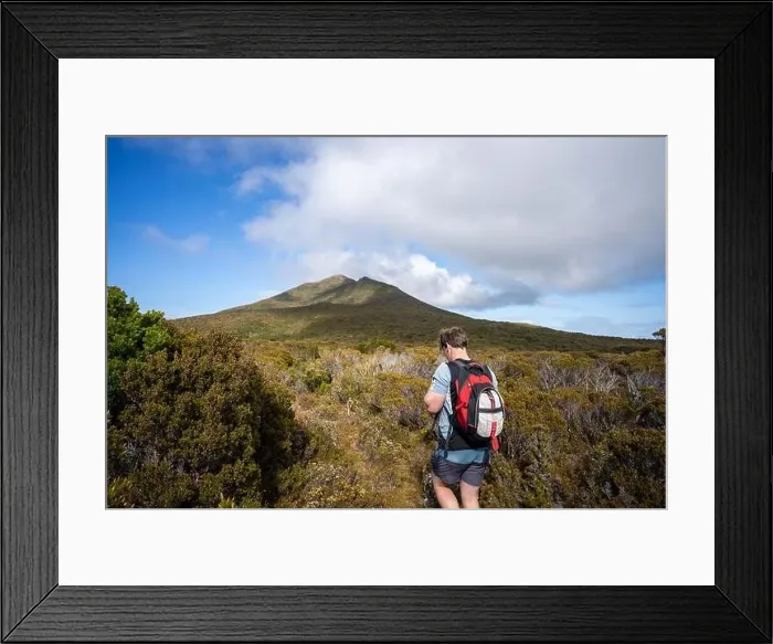 Framed Print : man hiking up a mountain with a backpack, alpine wilderness Framed Print : man hiking up a mountain with a backpack, alpine wilderness