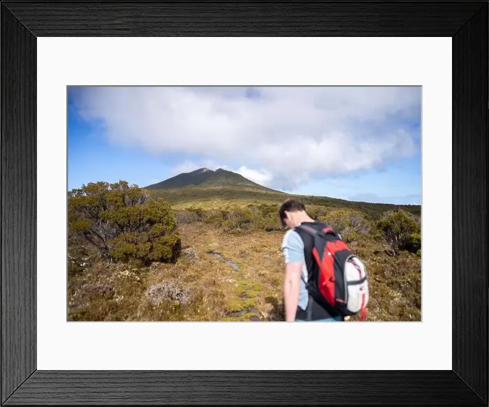 Framed Print : man hiking up a mountain with a backpack, alpine wilderness Framed Print : man hiking up a mountain with a backpack, alpine wilderness