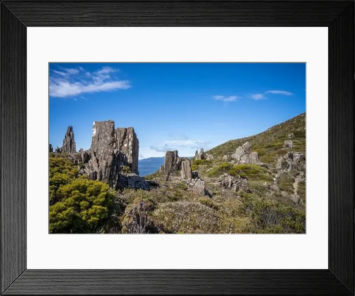 Framed Print : man hiking up a mountain with a backpack, alpine wilderness