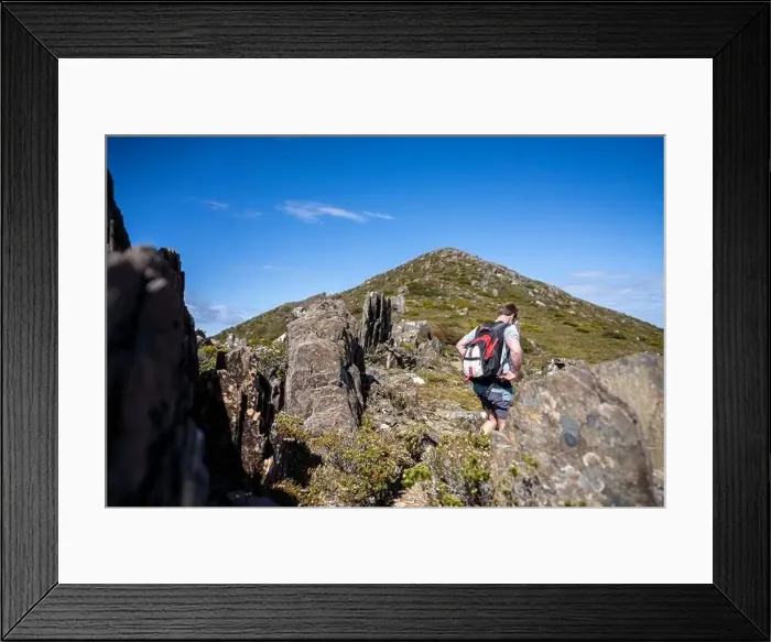 Framed Print : man hiking up a mountain with a backpack, alpine wilderness Framed Print : man hiking up a mountain with a backpack, alpine wilderness