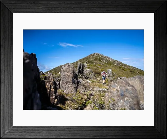 Framed Print : man hiking up a mountain with a backpack, alpine wilderness Framed Print : man hiking up a mountain with a backpack, alpine wilderness