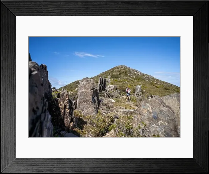 Framed Print : man hiking up a mountain with a backpack, alpine wilderness Framed Print : man hiking up a mountain with a backpack, alpine wilderness
