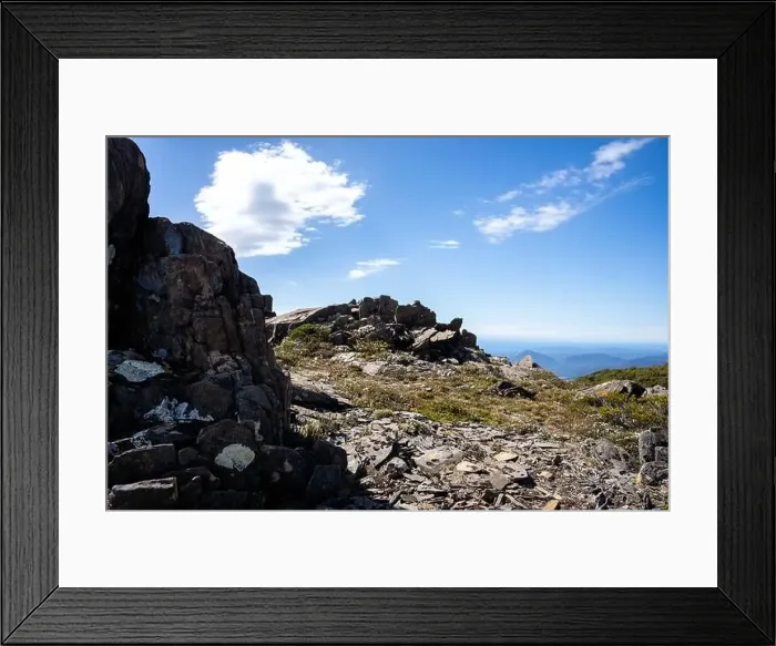 Framed Print : man hiking up a mountain with a backpack, alpine wilderness