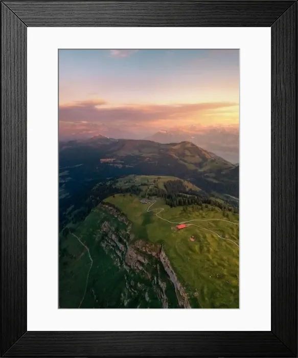 Framed Print : a drone shot on top of a mountain in the distance you can see the alps