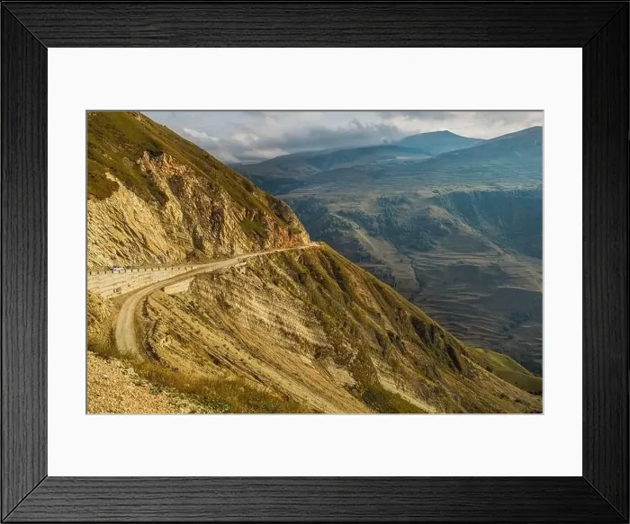 Framed Print : Winding road in the Dagestan Mountains with big mountain formation in the background Framed Print : Winding road in the Dagestan Mountains with big mountain formation in the background