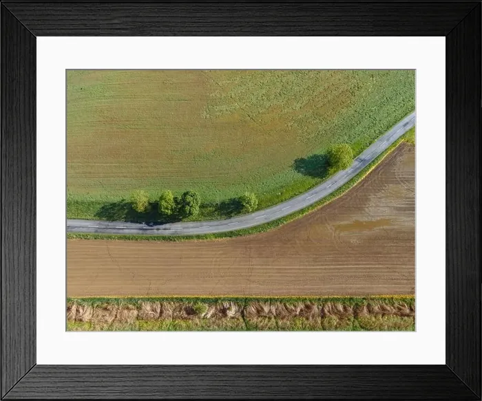 Framed Print : Aerial view of a winding stretch of road with trees and fields, Herencsény, Hungary Framed Print : Aerial view of a winding stretch of road with trees and fields, Herencsény, Hungary