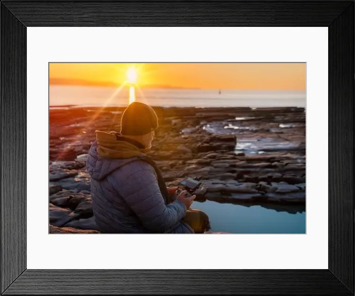 Framed Print : Bearded man using a drone with remote controller making photos and videos, having fun with new technology trends Framed Print : Bearded man using a drone with remote controller making photos and videos, having fun with new technology trends