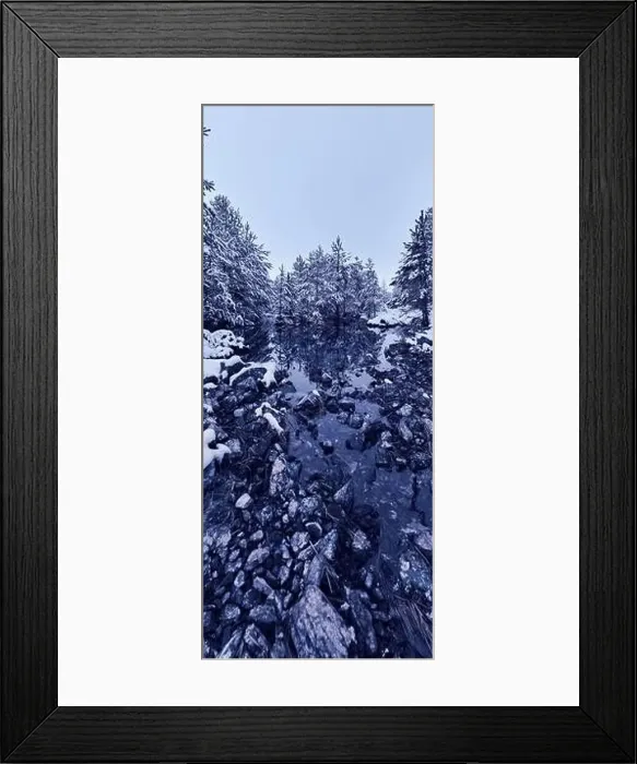 Framed Print : An aerial view of a frozen river flowing through snow-covered forests on a cloudy sunset sky background Framed Print : An aerial view of a frozen river flowing through snow-covered forests on a cloudy sunset sky background